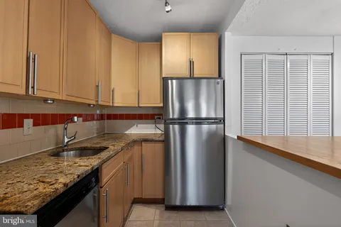 a kitchen with stainless steel appliances a refrigerator and a stove