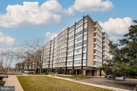 a view of a tall building next to a road
