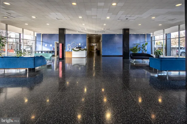 a living room with fireplace furniture and a large window