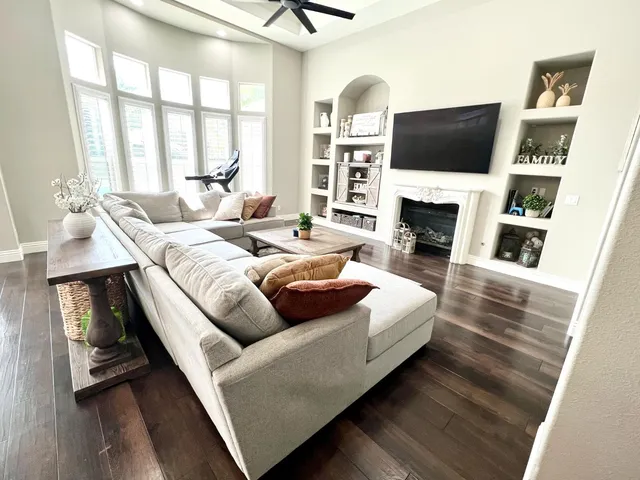 a living room with furniture fireplace and a flat screen tv