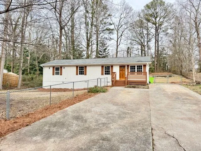 a view of a white house with a patio