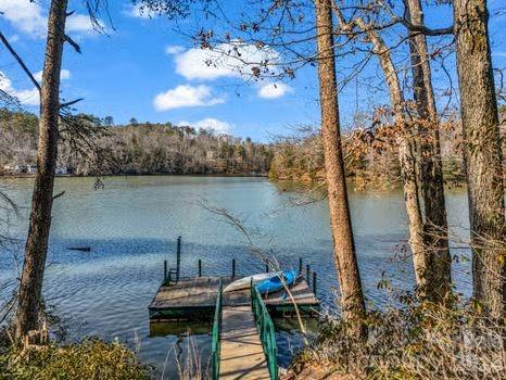 0 Hawk Ridge Drive, Unit 8 Mill Spring, NC 28756 - Photo 3 of 15 a view of a lake with a table and chairs