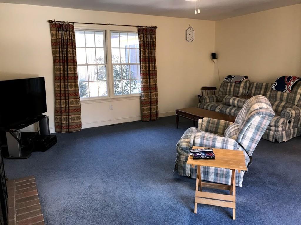 48 Catacunemaug Road Shirley, MA 01464 - Photo 20 of 28 a living room with furniture a ceiling fan and a window