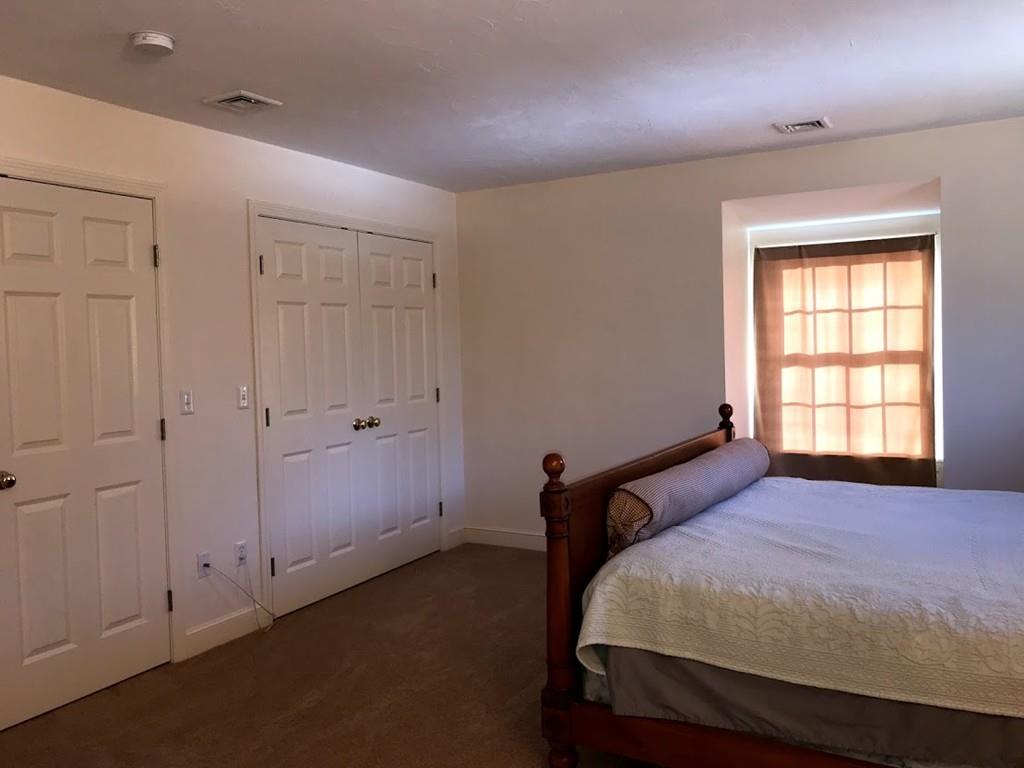 48 Catacunemaug Road Shirley, MA 01464 - Photo 25 of 28 a bedroom with a bed and a window
