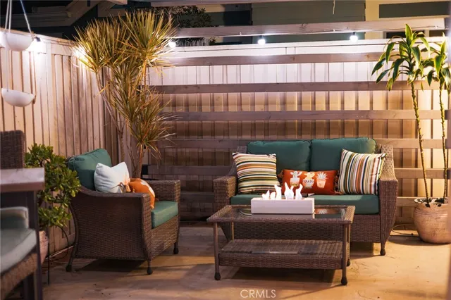 a outdoor sitting area with furniture and a potted plant