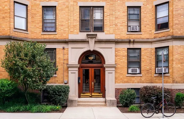 front view of a brick house with a large windows
