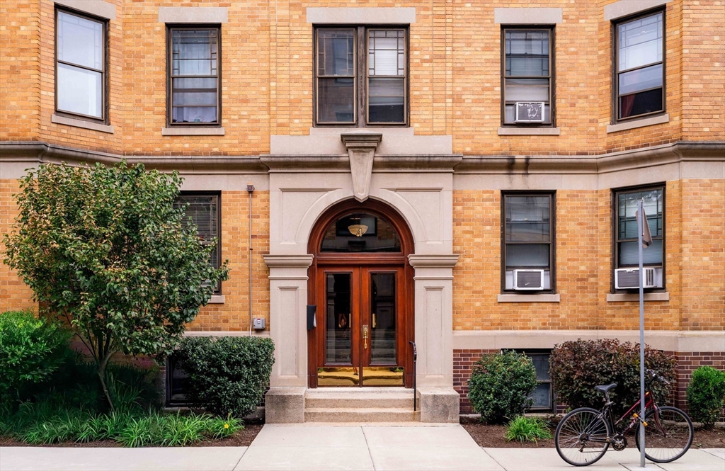 front view of a brick house with a large windows