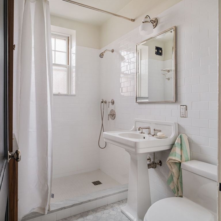 4 Newport Road, Unit 7 Cambridge, MA 02140 - Photo 23 of 31 a bathroom with a sink toilet and shower