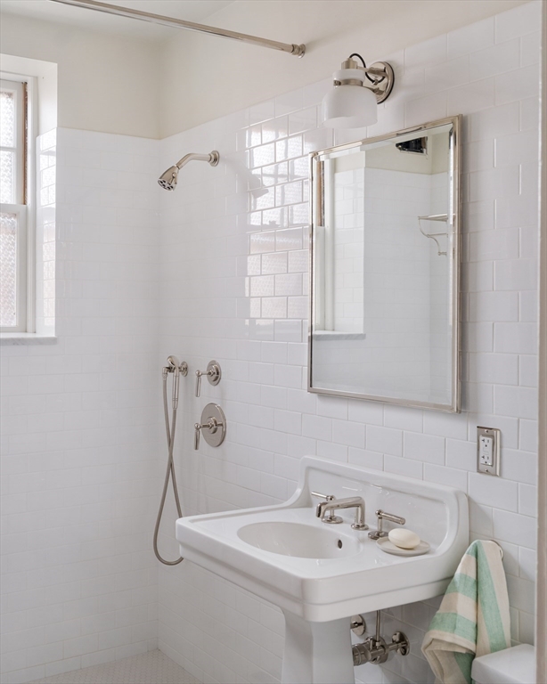 4 Newport Road, Unit 7 Cambridge, MA 02140 - Photo 24 of 31 a bathroom with a sink a mirror and a shower