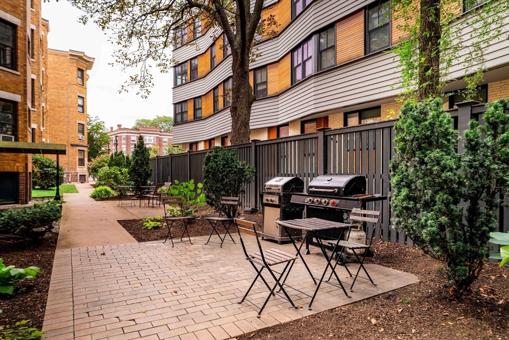 4 Newport Road, Unit 7 Cambridge, MA 02140 - Photo 30 of 31 a view of backyard with table and chairs and potted plants