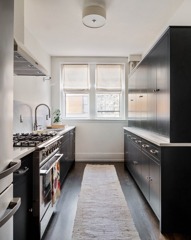 4 Newport Road, Unit 7 Cambridge, MA 02140 - Photo 5 of 31 a kitchen with a stove a sink and a refrigerator