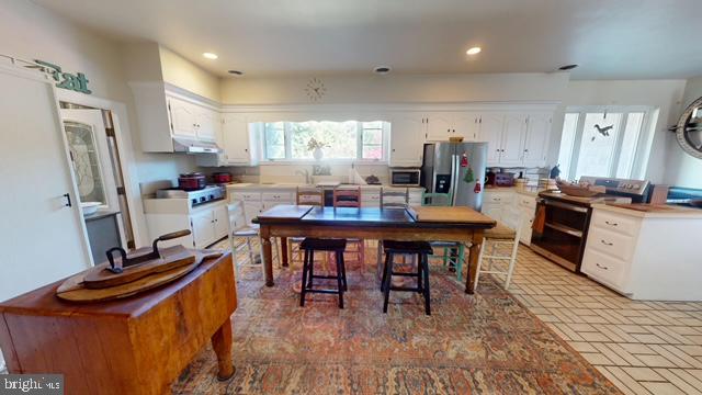 19 Valley Road Lewistown, PA 17044 - Photo 13 of 37 a kitchen with stainless steel appliances granite countertop dining table chairs sink and cabinets