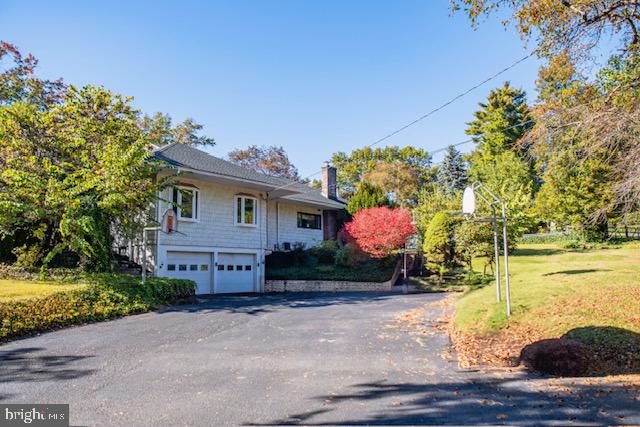 19 Valley Road Lewistown, PA 17044 - Photo 3 of 37 a front view of a house with a yard and a garage