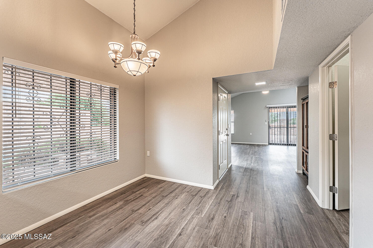 931 West Rio Guaymas Green Valley, AZ 85614 - Photo 18 of 39 a view of livingroom with window wooden floor and chandelier