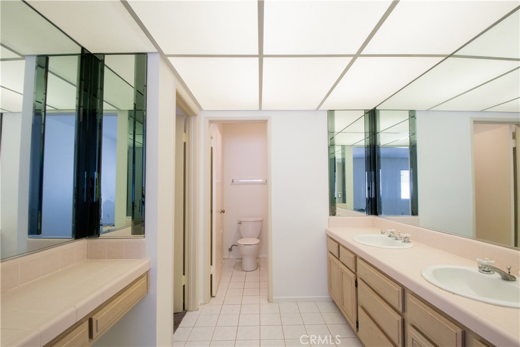 18340 Collins Street, Unit E Tarzana, CA 91356 - Photo 17 of 29 a bathroom with a sink a toilet and a shower