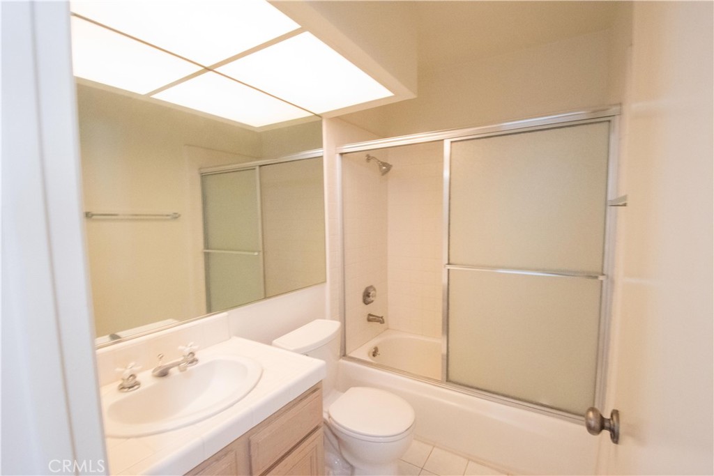 18340 Collins Street, Unit E Tarzana, CA 91356 - Photo 18 of 29 a bathroom with a sink toilet and shower