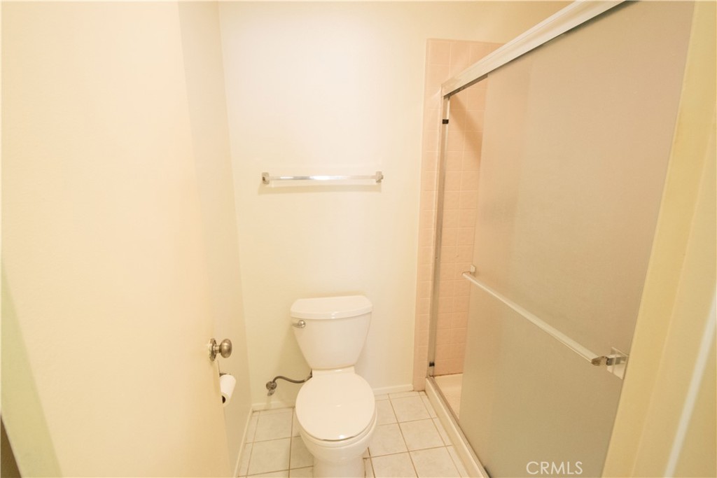 18340 Collins Street, Unit E Tarzana, CA 91356 - Photo 22 of 29 a bathroom with a toilet and a shower