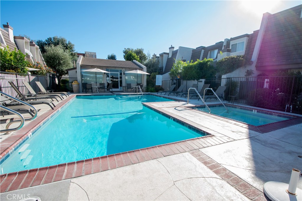 18340 Collins Street, Unit E Tarzana, CA 91356 - Photo 26 of 29 a view of a swimming pool with outdoor seating and plants