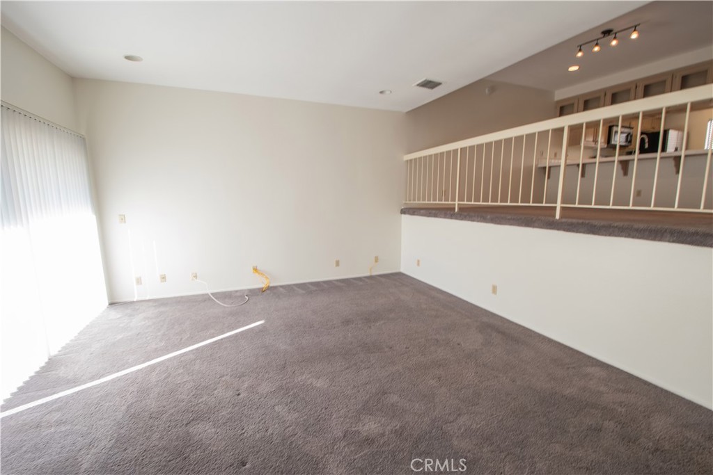 18340 Collins Street, Unit E Tarzana, CA 91356 - Photo 6 of 29 a view of an empty room with stairs
