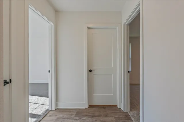 a view of a room with wooden floor and window
