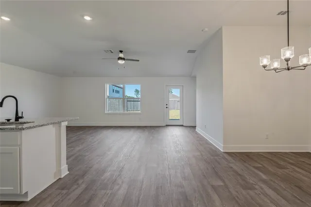 a view of a room with wooden floor and chandelier