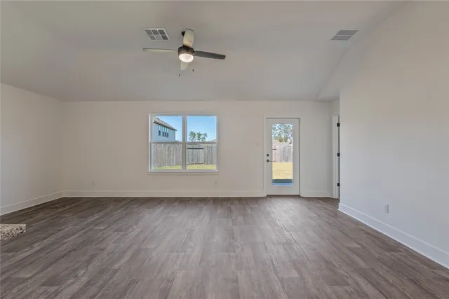 a large kitchen with cabinets wooden floor and stainless steel appliances