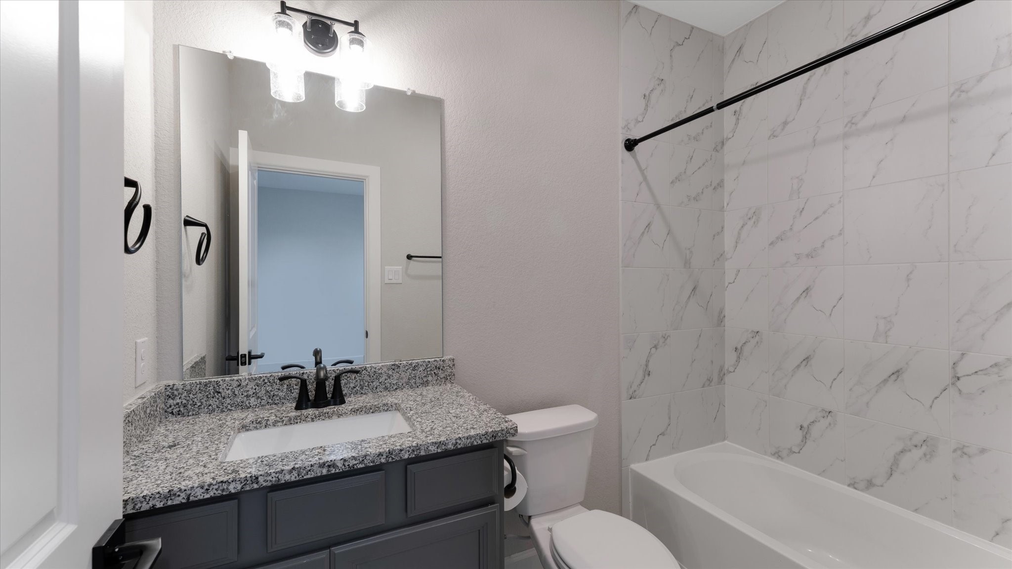 15607 Rising Wren Court Conroe, TX 77302 - Photo 30 of 40 a bathroom with a granite countertop sink toilet and shower