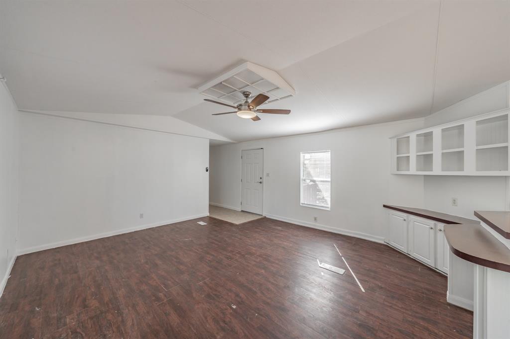 419 Wood River Road Millsap, TX 76066 - Photo 12 of 36 an empty room with wooden floor and windows