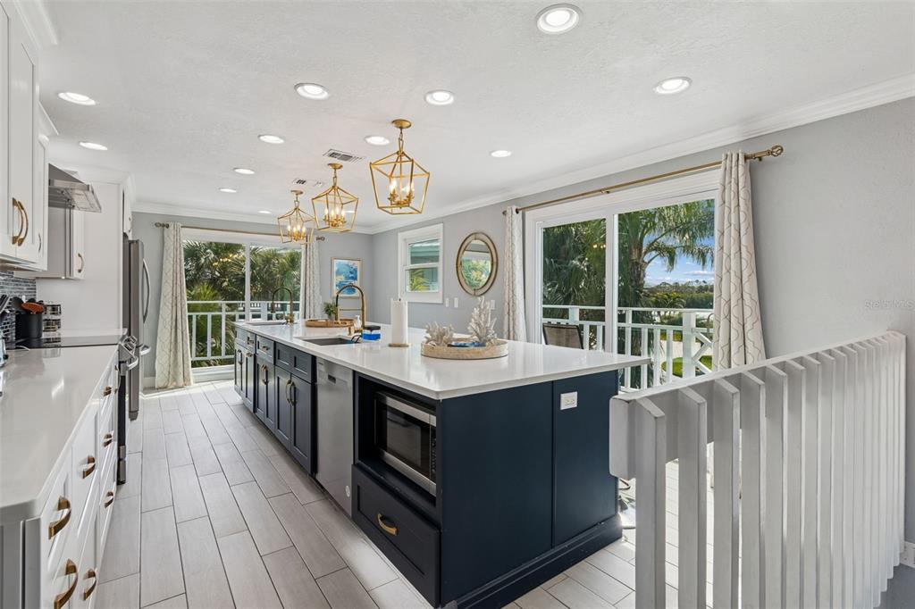 330 6th Avenue Indian Rocks Beach, FL 33785 - Photo 6 of 52 a kitchen with stainless steel appliances granite countertop a stove and a large window