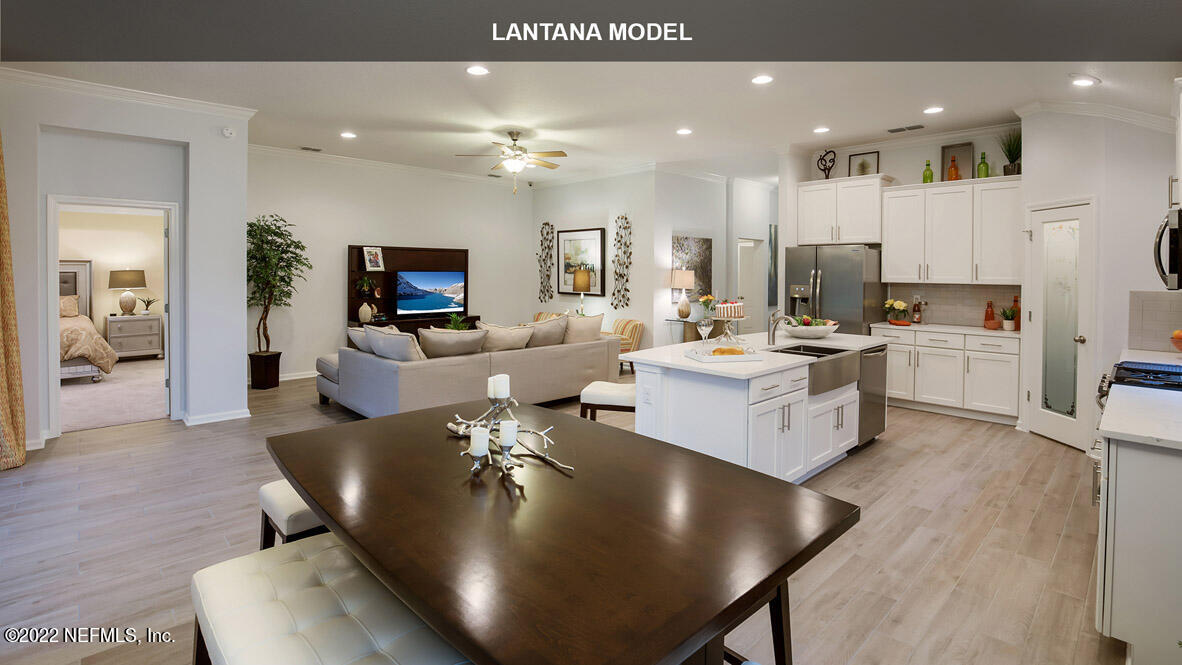 65736 Edgewater Drive Yulee, FL 32097 - Photo 6 of 44 a living room with stainless steel appliances furniture a dining table and kitchen view