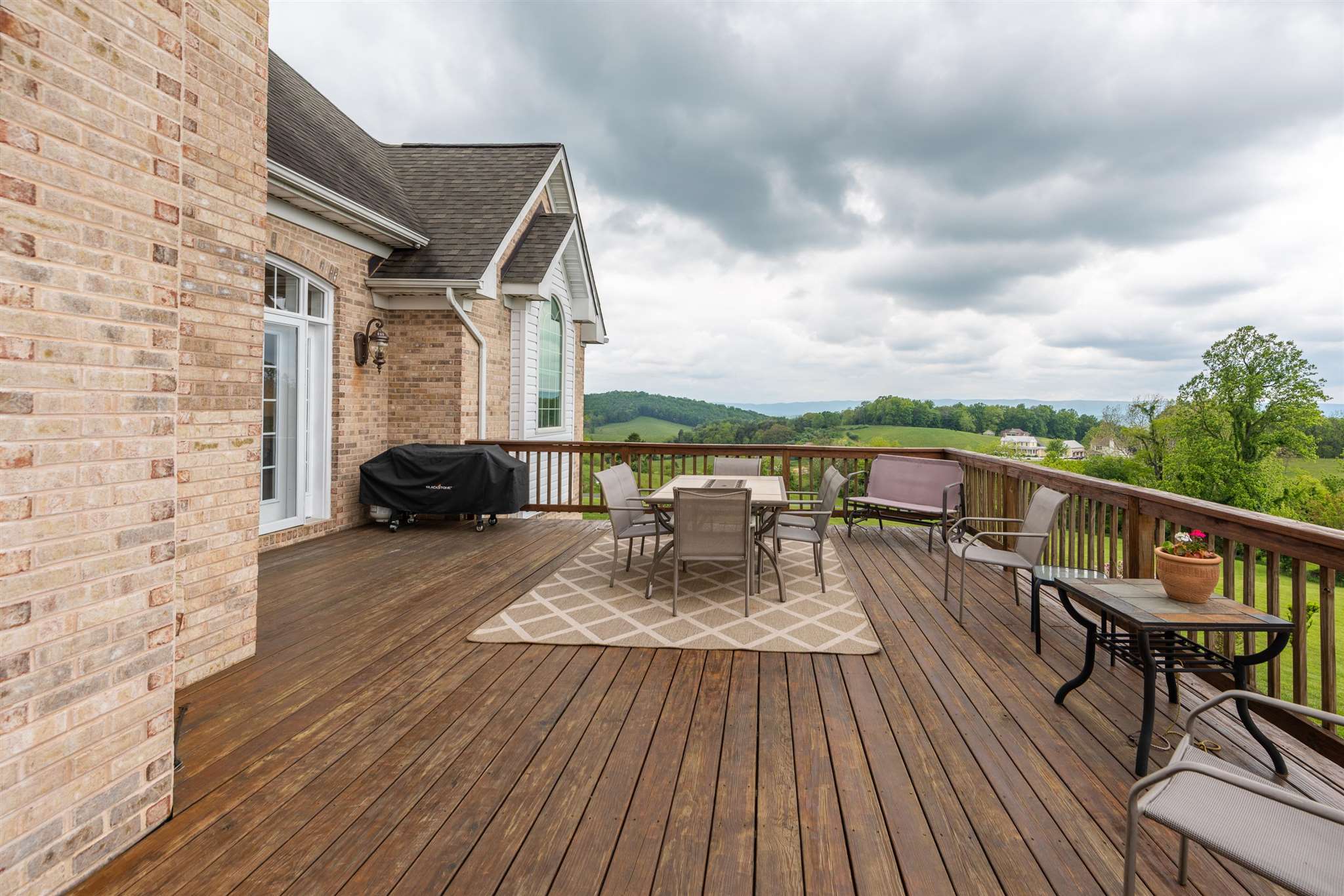 60 Koogler Trail Raphine, VA 24472 - Photo 60 of 75 a balcony with wooden floor table and chairs