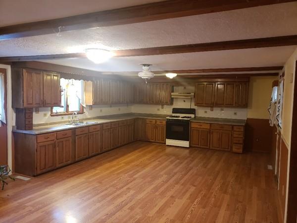 912 Walnut Plain Road Rochester, MA 02770 - Photo 6 of 20 a kitchen with stainless steel appliances kitchen island granite countertop a sink cabinets and wooden floor