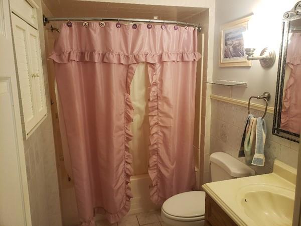 912 Walnut Plain Road Rochester, MA 02770 - Photo 8 of 20 a bathroom with a shower curtain and sink