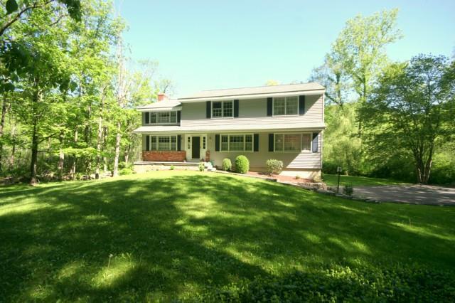 194 Peaceable Street Ridgefield, CT 06877 - Photo 1 of 1 a view of a house with a yard table and chairs