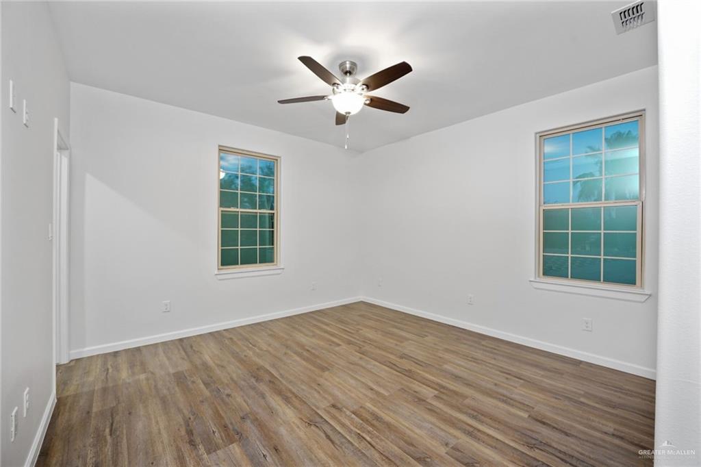 2906 Alcala Court Mission, TX 78572 - Photo 12 of 17 wooden floor in an empty room with a window