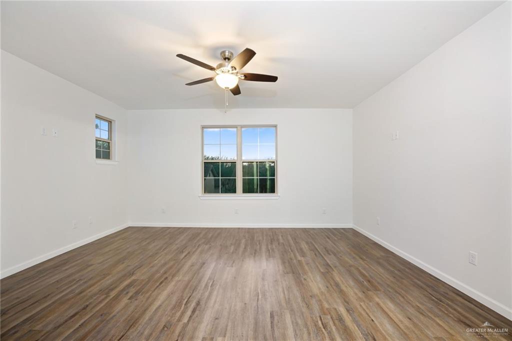 2906 Alcala Court Mission, TX 78572 - Photo 8 of 17 a view of an empty room with wooden floor and a window