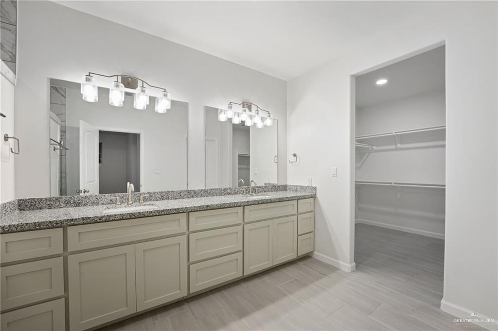 2906 Alcala Court Mission, TX 78572 - Photo 9 of 17 a bathroom with a double vanity sink and a mirror