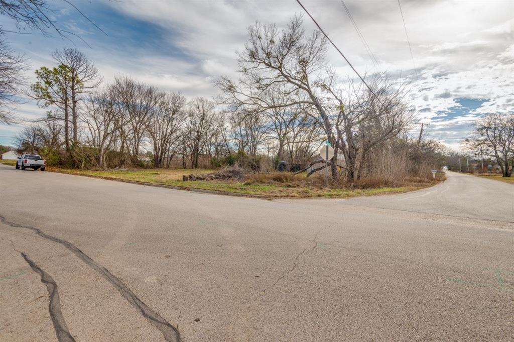 208 West 9th Street Kemp, TX 75143 - Photo 10 of 13 a view of a road with large trees
