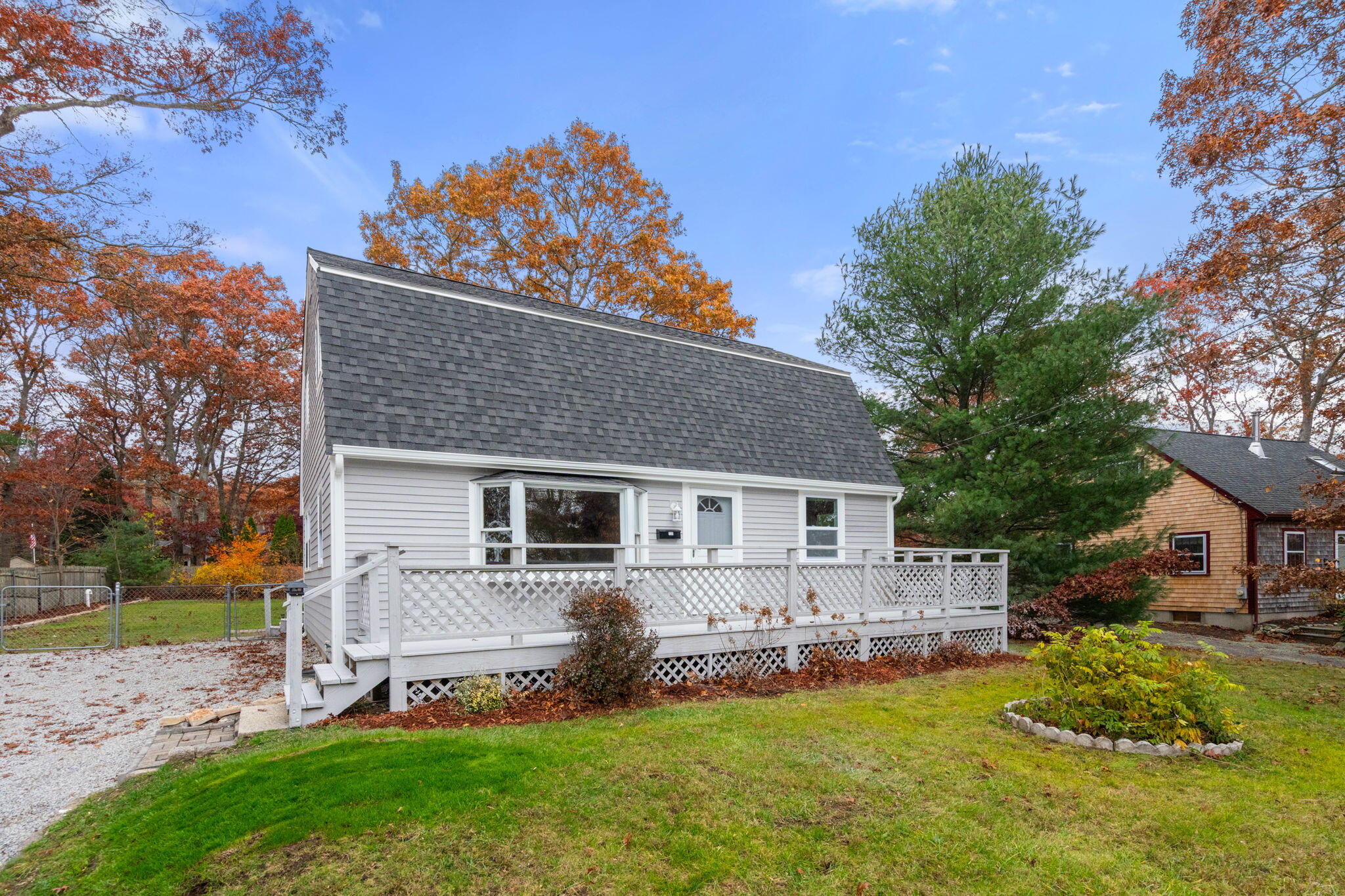 130 Old Barnstable Road East Falmouth, MA 02536 - Photo 1 of 34 a front view of house with a garden and patio