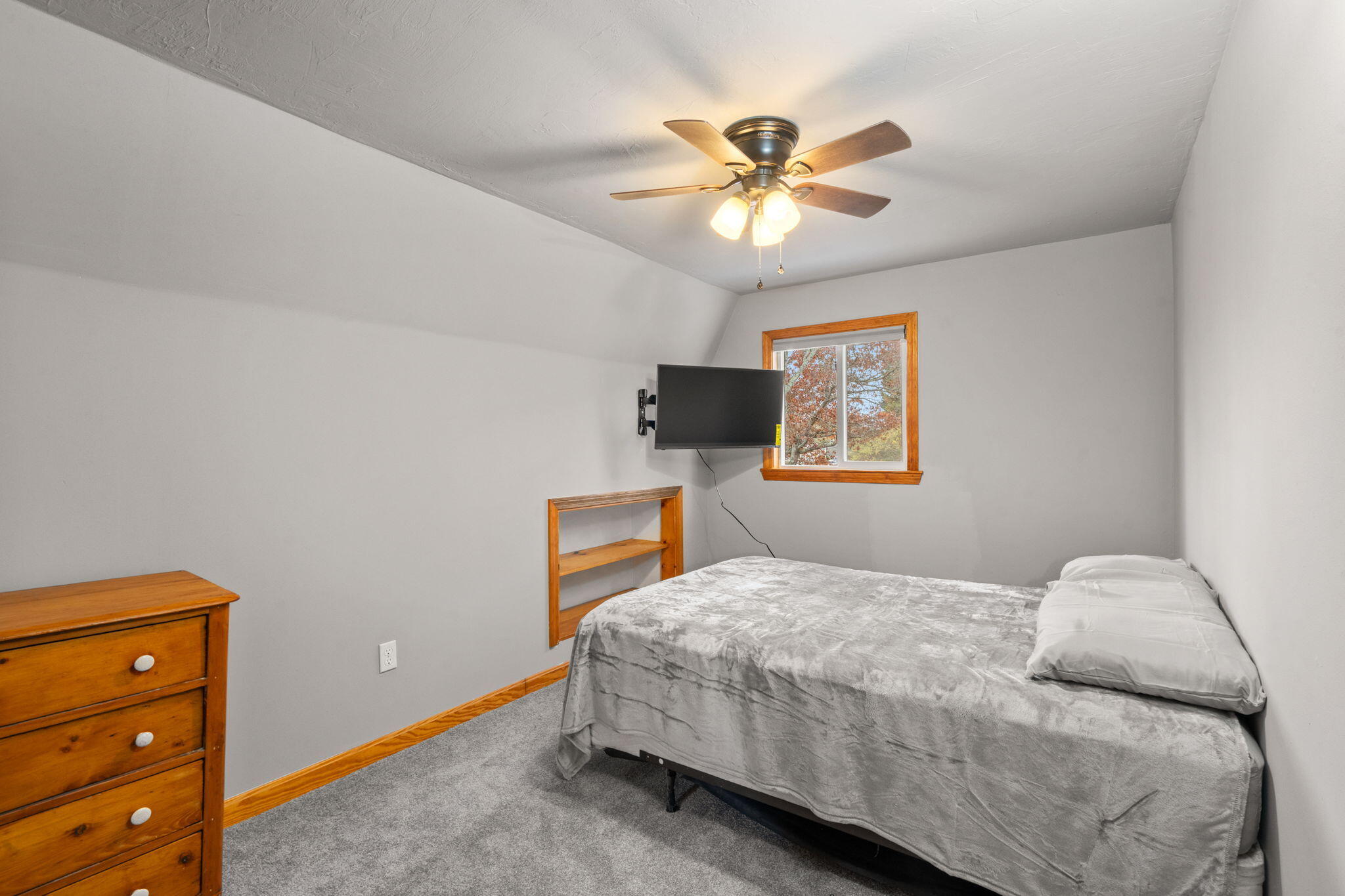 130 Old Barnstable Road East Falmouth, MA 02536 - Photo 14 of 34 a bedroom with a bed and a chandelier