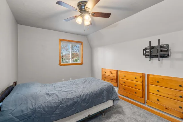 a bedroom with a bed and a dresser