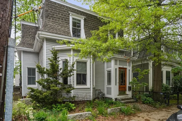 front view of a house with a tree