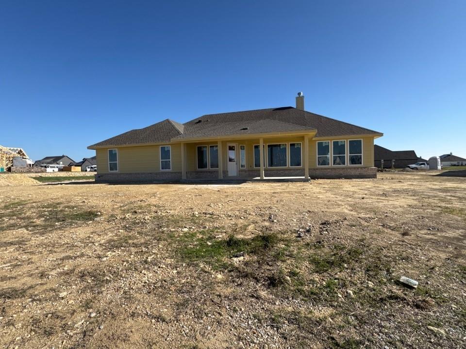 111 Brandywine Trail Rhome, TX 76078 - Photo 11 of 13 a front view of a house with a yard