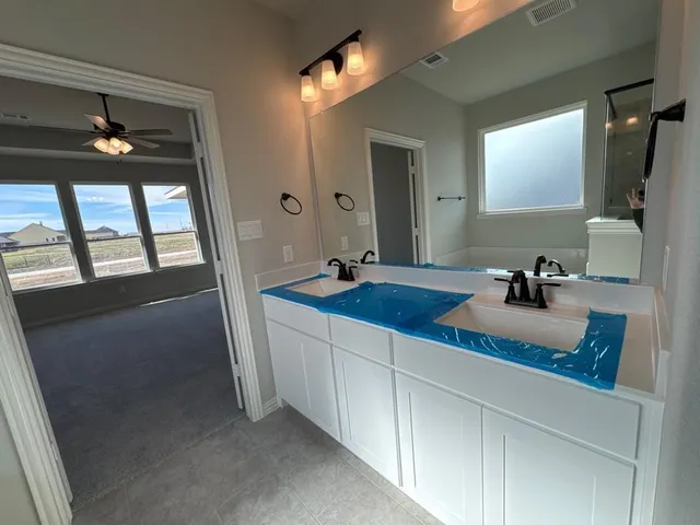 a bathroom with a double vanity sink and a mirror