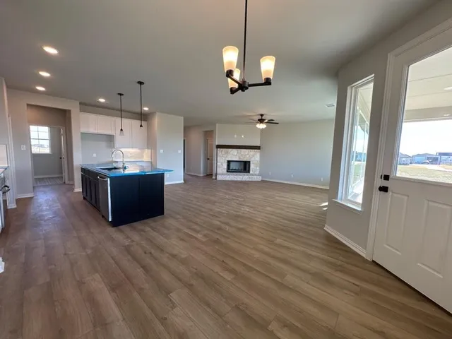a view of a kitchen with a dishwasher cabinets and wooden floor
