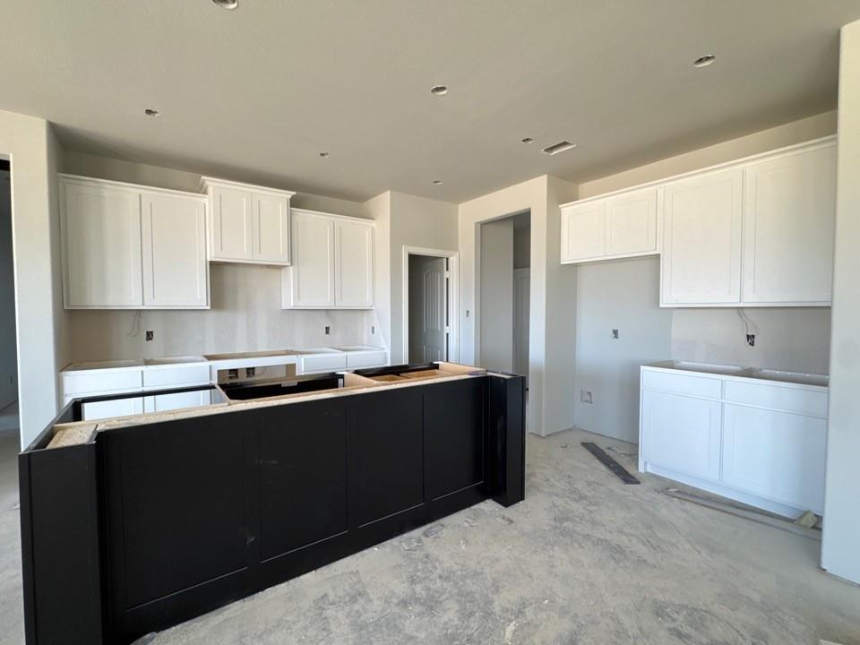 111 Brandywine Trail Rhome, TX 76078 - Photo 7 of 13 a kitchen with stainless steel appliances sink stove and cabinets