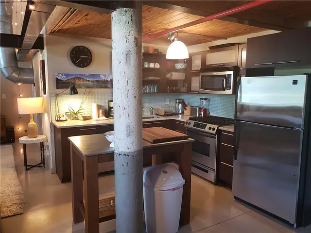 a kitchen with cabinets and stainless steel appliances