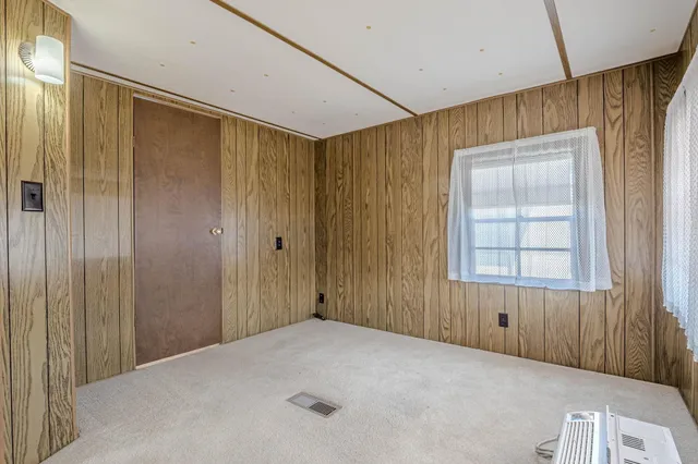 a bathroom with a toilet a sink a mirror and a window