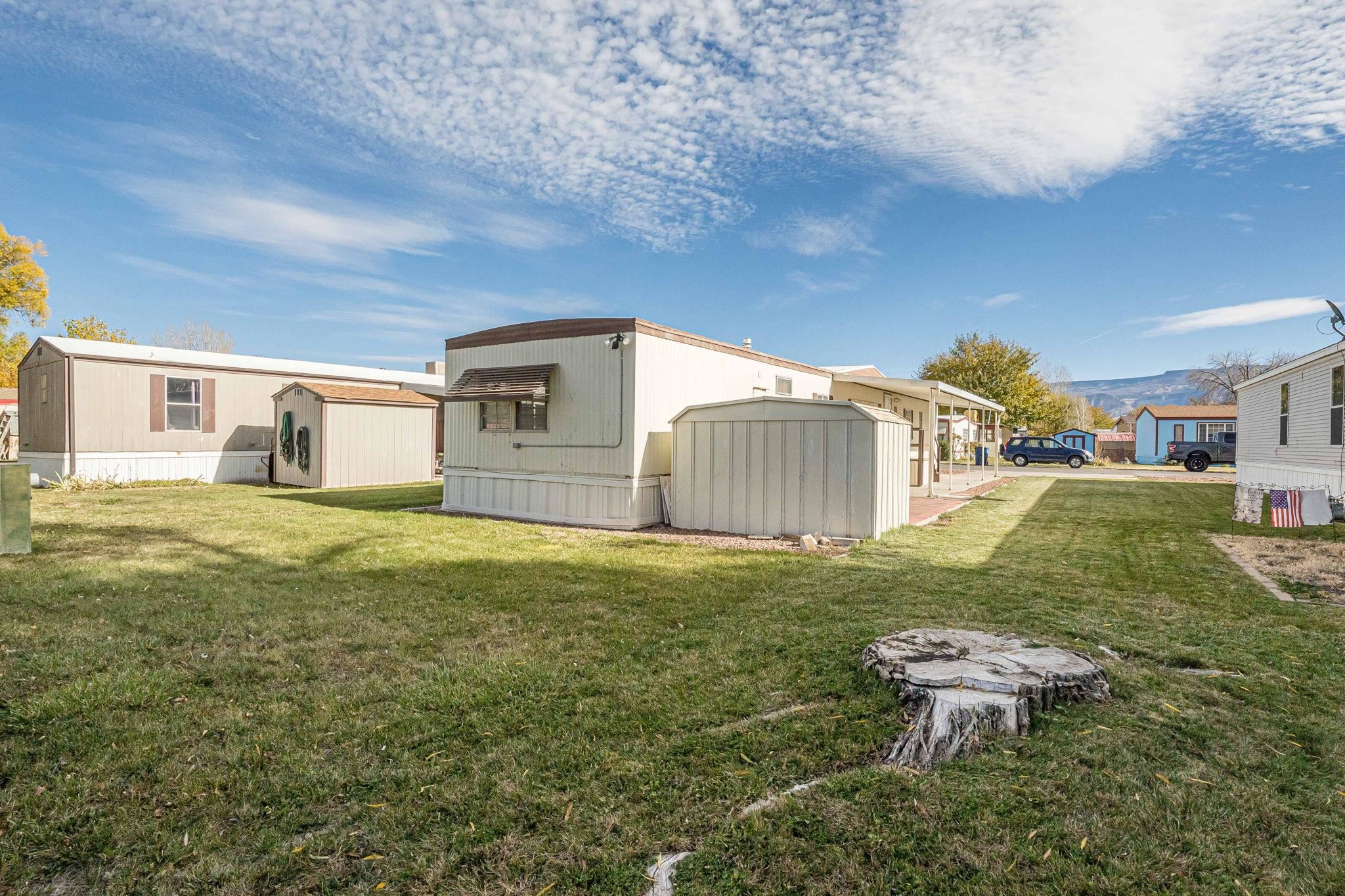 3251 E Road, Unit 22 Clifton, CO 81520 - Photo 26 of 29 a backyard of a house with table and chairs