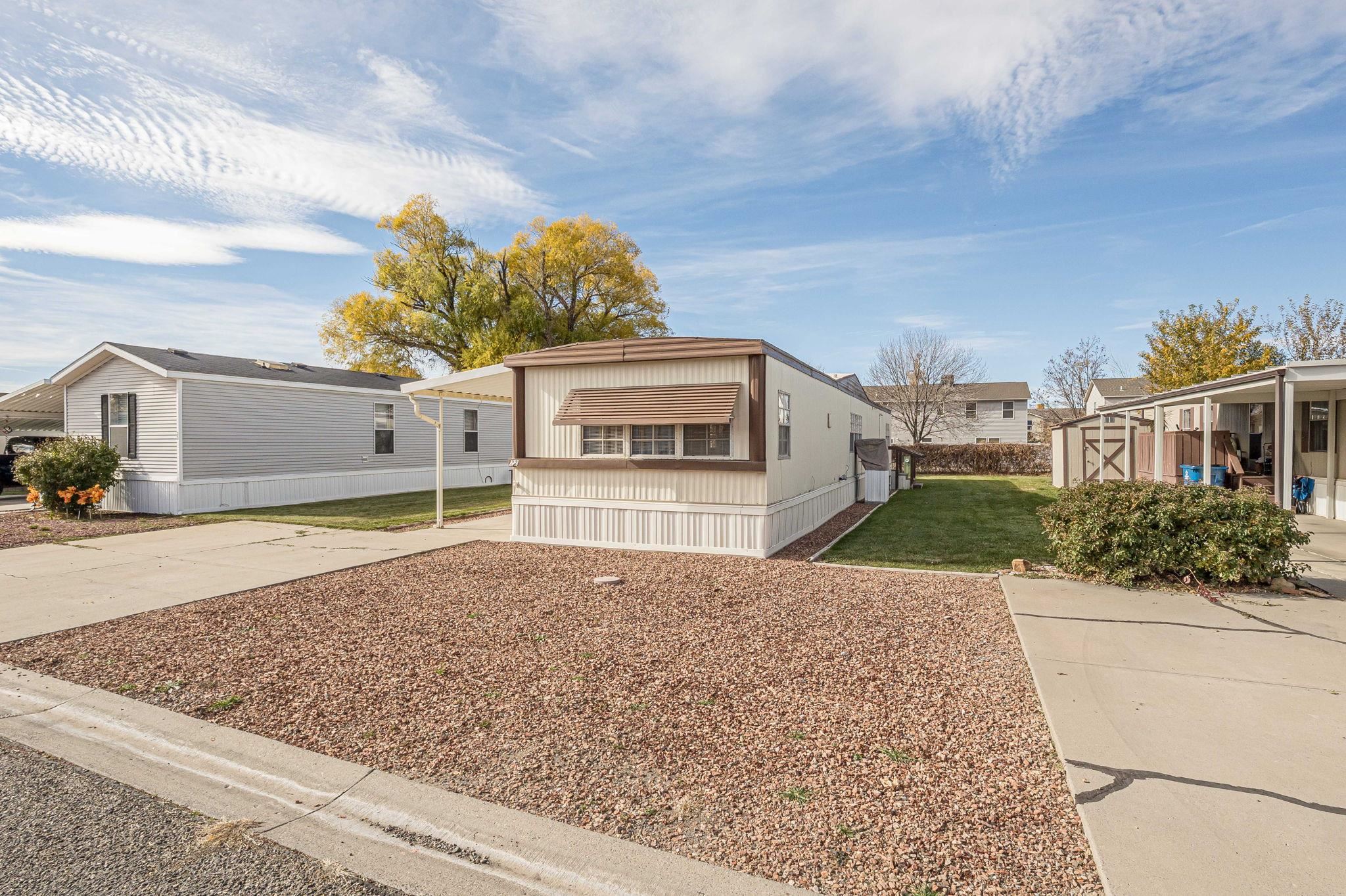 3251 E Road, Unit 22 Clifton, CO 81520 - Photo 28 of 29 a front view of a house with a yard and potted plants